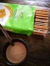 Hot Milo is served with Julie`s cream crackers as a snack for kids.