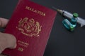 Malaysia passport, vials, syringe. Medical health concept.