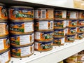 Selected focused on tuna fish fillet in the cans and displayed for sale on shelves in the supermarket. Royalty Free Stock Photo