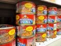 Selected focused on tuna fish fillet in the cans and displayed for sale on shelves in the supermarket. Royalty Free Stock Photo