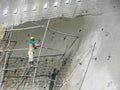 Construction workers are spraying liquid concrete onto the slope surface to form a retaining wall layer. Royalty Free Stock Photo