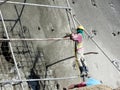 Construction workers are spraying liquid concrete onto the slope surface to form a retaining wall layer.