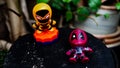 Two McDonald's toy Deadpool lay on the ground and Spiderman stand up