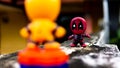 Two McDonald's toy Deadpool and orange spiderman having a final fight on the road Royalty Free Stock Photo