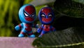 Spiderman toys from McDonald`s behind the bushes. Royalty Free Stock Photo