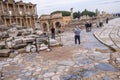 Several tourists taking photos in front of Celsus Library in Ephesus ruins, historical ancient Roman archaeological sites