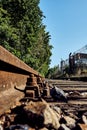 Seldom used, weathered railway line that is gradually overgrown by plants.