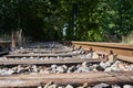 Seldom used, weathered railway line that is gradually overgrown by plants