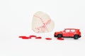 Selecitive focus miniature red car ,present heart box and red heart on white background, copy space. Idea surprise gift for