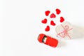 Selecitive focus miniature red car ,present heart box and red heart on white background, copy space. Idea surprise gift for