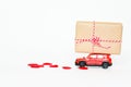 Selecitive focus miniature red car ,present heart box and red heart on white background, copy space. Idea surprise gift for