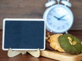 Select focus of blackboard in front of multiple color cookies inclusive peanut butter, green tea cookies, and Chocolate Chip Cooki Royalty Free Stock Photo