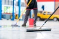 Select the focus mop, service staff man using a mop to remove water in the uniform cleaning the protective clothing of the new Royalty Free Stock Photo