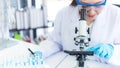 Select focus. Scientists analyzing study data and evaluating microscope success for work shop Royalty Free Stock Photo