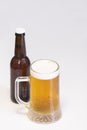 Select focus of a tempting cold mug of beer with an out of focus beer bottle at the back Royalty Free Stock Photo