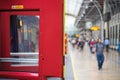 Train door with blurred passengers in the background Royalty Free Stock Photo