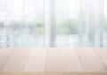 Select tive focus.Empty wood table top on blur abstract window glass background
