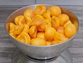 Selected apricots are halved and pips removed and prepared for weighing