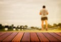 Selected focus empty wooden table and view of sport man blur background with bokeh image. for your photomontage or product Royalty Free Stock Photo