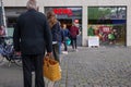 European people queue and social distancing outside in front of REWE supermarket during COVID-19. Royalty Free Stock Photo