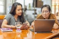 Selected focus laptop on table with mother and daughter spend time watching movie together as Family time. Royalty Free Stock Photo