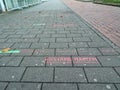 Selected focus low angle view in Abstand halten means keep your distance on a sidewalk in a German city center