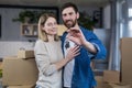 Selected focus, married couple man and woman happy together, hugging, holding the keys to their new apartment, housewarming, close Royalty Free Stock Photo