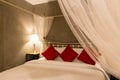 Selected focus mosquito net on four-poster bed Royalty Free Stock Photo