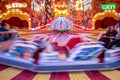 Amusement ride of carousel with movement of rotating sloping platform.