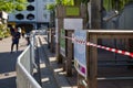 Red and white caution tape restrict outdoor eating area of cafe and restaurant which closed during epidemic of COVID-19 Royalty Free Stock Photo