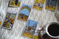 Selected focus of tarot cards layout, cup of Coffee and notebook. Royalty Free Stock Photo