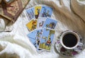 Selected focus of tarot cards layout, cup of Coffee and notebook. Royalty Free Stock Photo