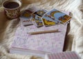 Selected focus of tarot cards layout, cup of Coffee and notebook. Royalty Free Stock Photo