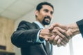 Selected focus on two businessman hands shake in the meeting room. Businessmand hand shake as a greeting Royalty Free Stock Photo