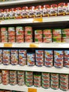 Selected focused on tuna fish fillet in the cans and displayed for sale on shelves in the supermarket. Royalty Free Stock Photo