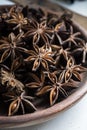 selected star anise stars on a wooden bowl.