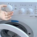 Selecting wash program on washing machine control panel Royalty Free Stock Photo