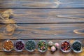 Selection of assorted teas in transparent little bowls on natural background