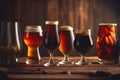 A selection of beers in different glasses on an old rustic wooden table