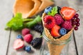 Selection of berries in ice cream cones - healthy dessert concept