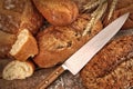 A selection of bread loaves with knife Royalty Free Stock Photo