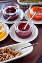 A selection of breakfast toppings, jam, honey, sauces