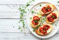 Gourmet Bruschetta With Roasted Tomatoes and Fresh Basil on a White Plate Royalty Free Stock Photo