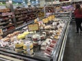Cakes in refrigerated display in suburban supermarket bakery section. Wide selection of various cakes to entice customer