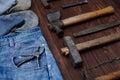 A selection of carpenter worn tools kit and denim jeans with gloves