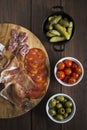 Selection of charcuterie and tapas dishes on a wooden table