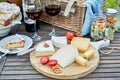 Selection of cheese on a cheeseboard at a picnic