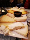 Selection of cheeses with sweet sauce, Spanish tapa served on a white plate