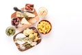 Selection of cheeses with variety of antipasti on wooden boards - olives, baby and sun dried tomatoes Royalty Free Stock Photo