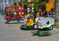 A selection of colorful electric powered sit on rides for infants and toddlers in an amusement centre in a local shopping mall in